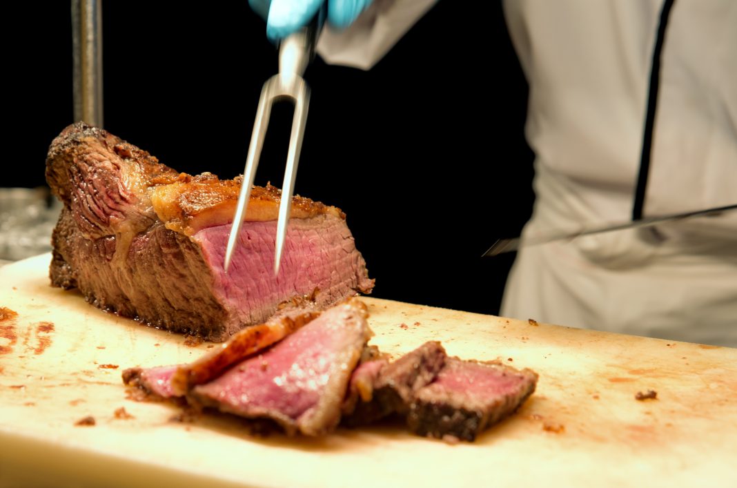 Cooked Prime Rib being cut and served