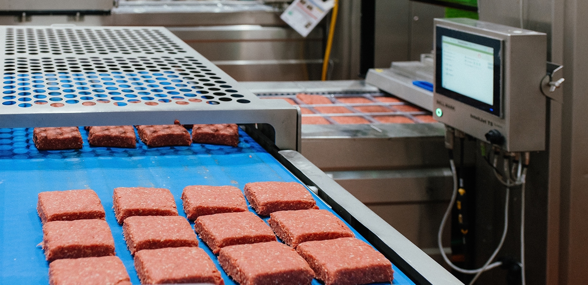 meat being processed on a conveyor belt