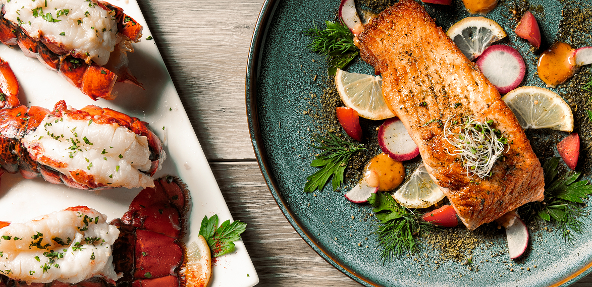 Value Added fish and lobsters plated on a table